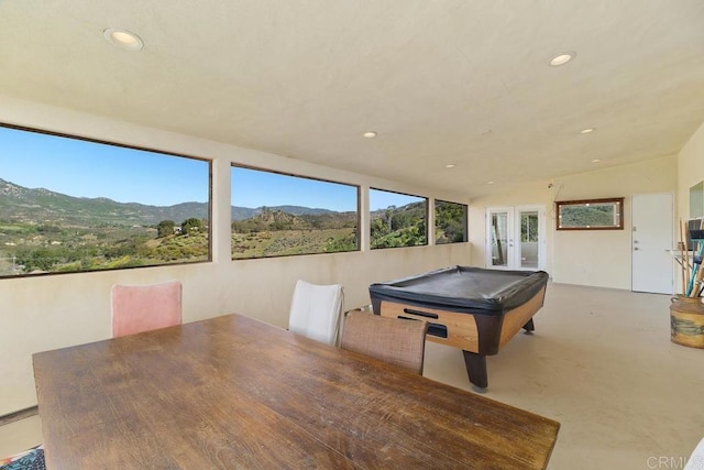 playroom with pool table, finished concrete floors, recessed lighting, french doors, and a mountain view