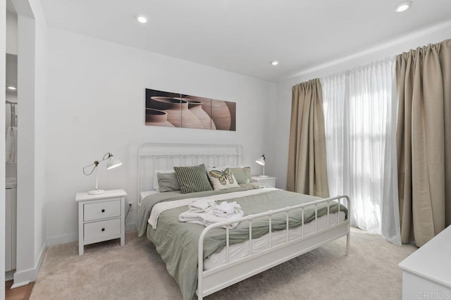 bedroom featuring light carpet, baseboards, and recessed lighting