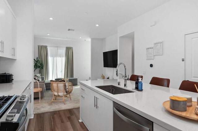 kitchen with visible vents, appliances with stainless steel finishes, light countertops, and a sink