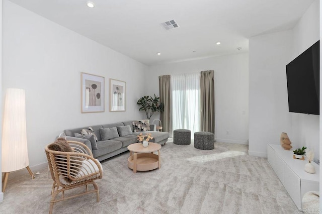 carpeted living area featuring recessed lighting, visible vents, and baseboards