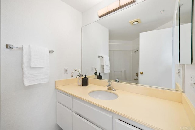 bathroom with a shower and vanity