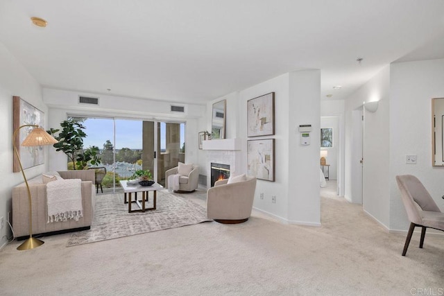 carpeted living room featuring a brick fireplace, baseboards, and visible vents