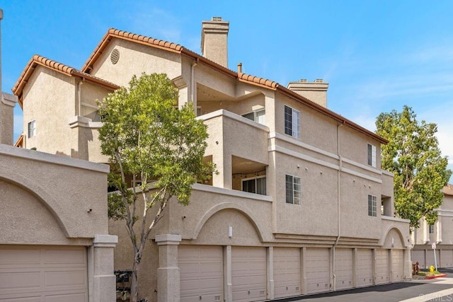 view of building exterior with community garages