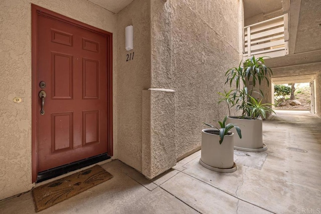 doorway to property with stucco siding