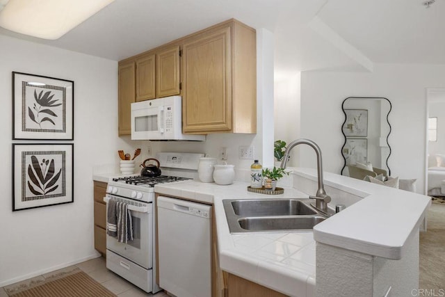 kitchen with tile countertops, light tile patterned floors, a peninsula, white appliances, and a sink