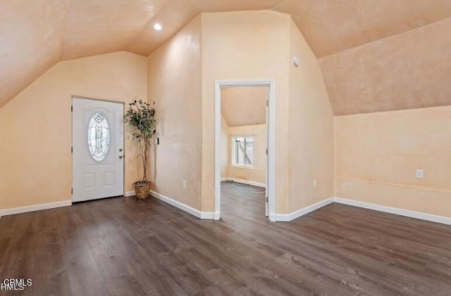 entrance foyer with lofted ceiling, dark wood-style floors, and baseboards