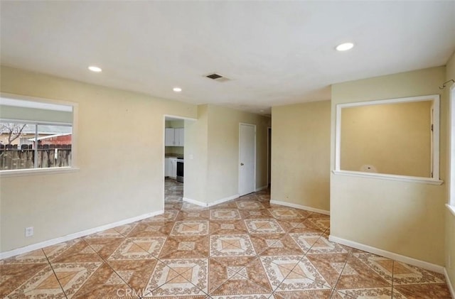 tiled spare room featuring recessed lighting, visible vents, and baseboards