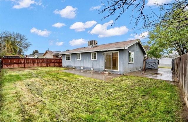 rear view of property with a patio area, a fenced backyard, a lawn, and central AC unit