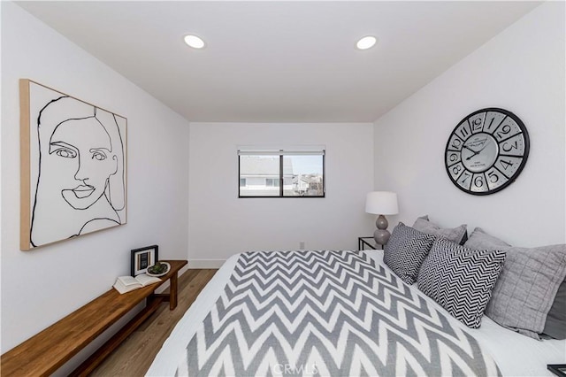 bedroom with recessed lighting and wood finished floors