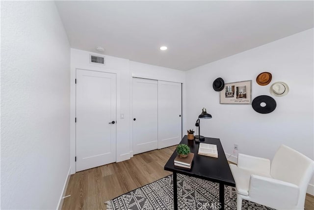 home office with wood finished floors, visible vents, and recessed lighting