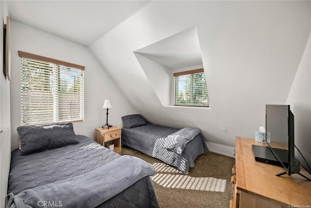 bedroom featuring lofted ceiling and carpet floors