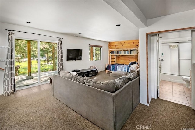 tiled living area featuring recessed lighting and carpet