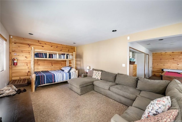 bedroom with wooden walls and carpet