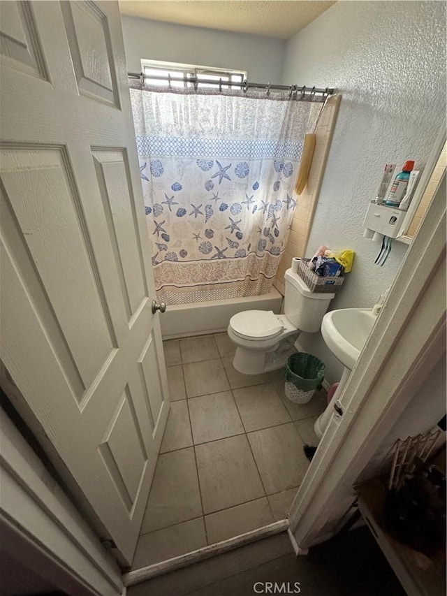 full bath with tile patterned flooring, toilet, a textured wall, shower / bath combination with curtain, and a textured ceiling