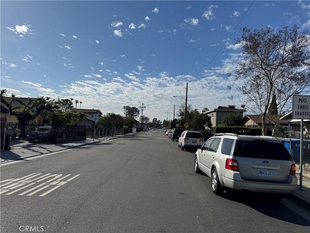 view of street featuring curbs, street lights, and sidewalks