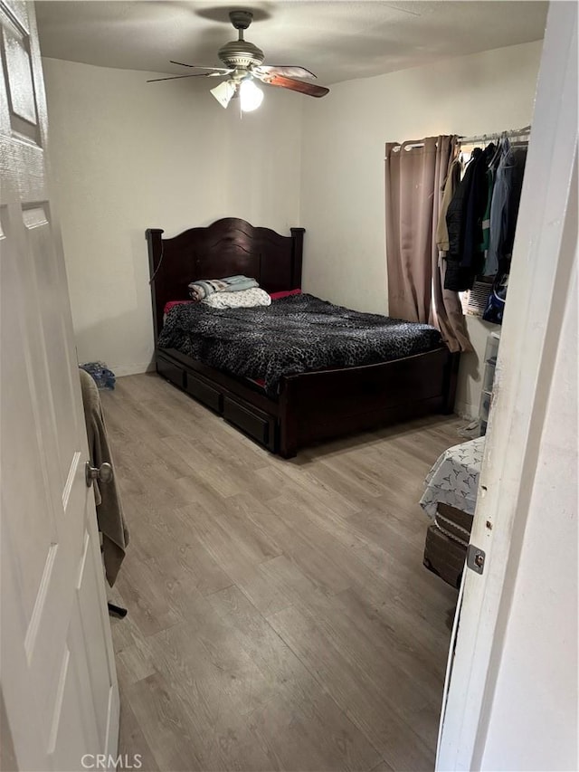 bedroom featuring a ceiling fan and wood finished floors