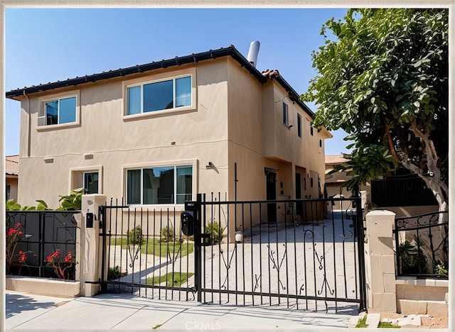 view of gate with a fenced front yard