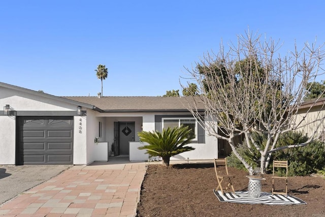 ranch-style house with an attached garage and stucco siding