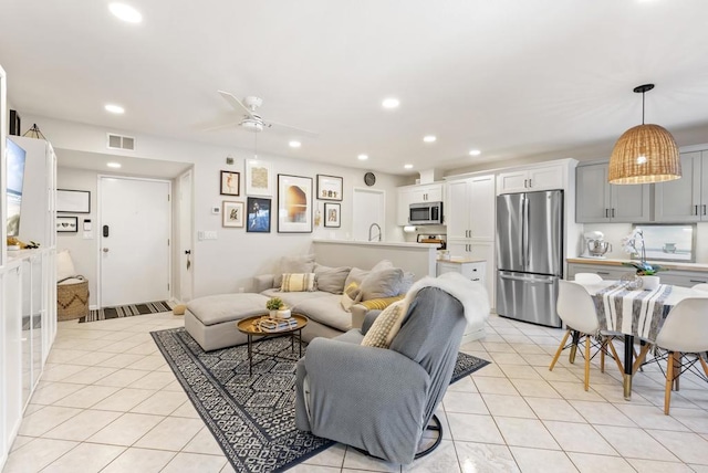 living room with light tile patterned floors, visible vents, recessed lighting, and ceiling fan