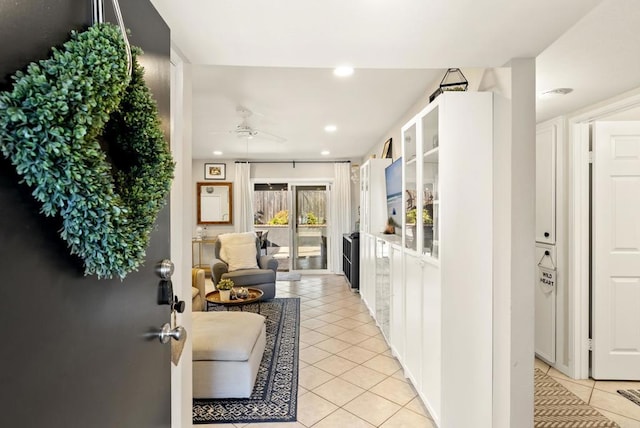 hallway with light tile patterned floors and recessed lighting