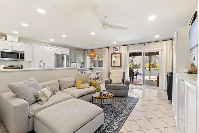 living area with light tile patterned floors, recessed lighting, a wealth of natural light, and ceiling fan