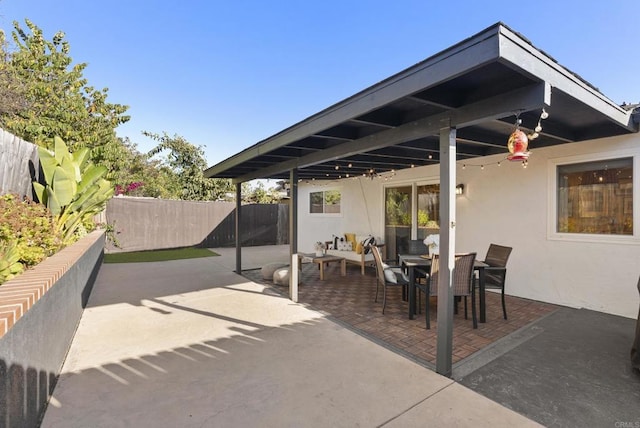 view of patio with outdoor dining area and fence