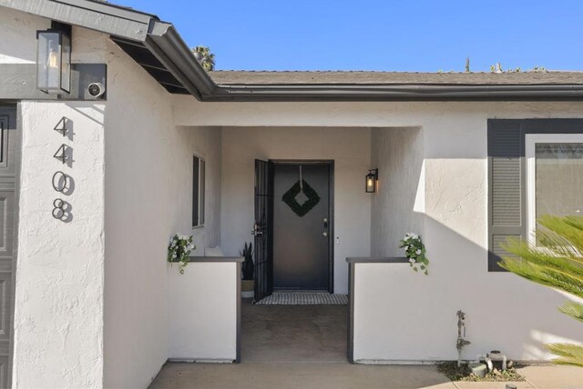 entrance to property with stucco siding