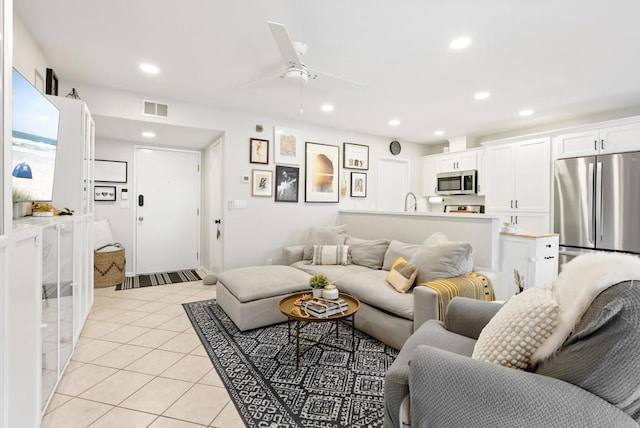 living room featuring light tile patterned floors, visible vents, recessed lighting, and a ceiling fan