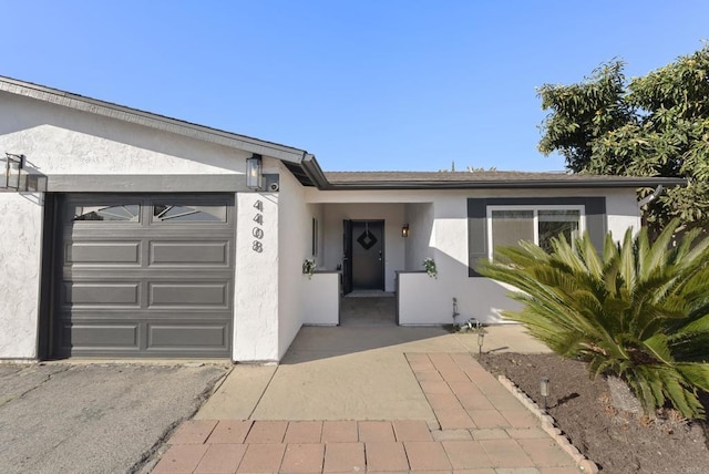 single story home with stucco siding and a garage