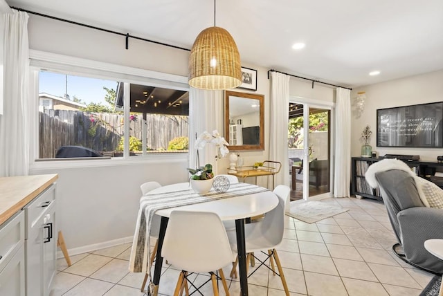 dining room with light tile patterned flooring, recessed lighting, and baseboards