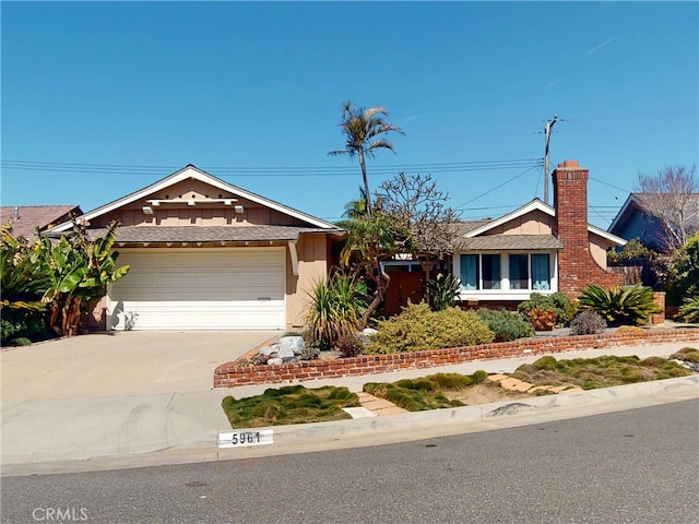 ranch-style home featuring an attached garage and concrete driveway