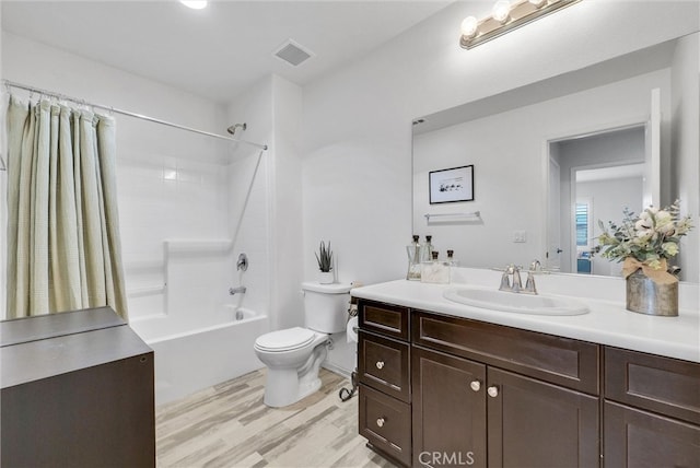 full bath with toilet, wood finished floors, vanity, bathing tub / shower combination, and visible vents