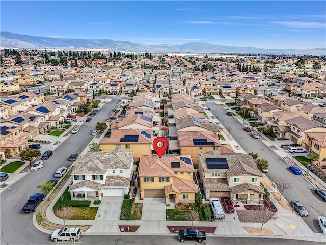 drone / aerial view featuring a residential view and a mountain view