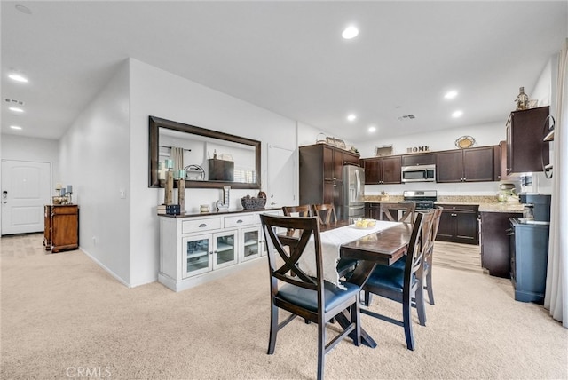 dining space featuring light carpet, baseboards, visible vents, and recessed lighting