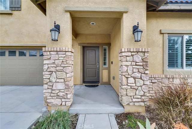 doorway to property featuring stone siding and stucco siding