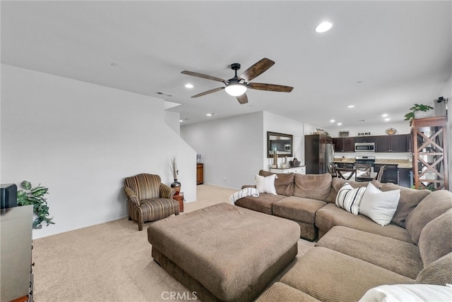 living area featuring light carpet, ceiling fan, visible vents, and recessed lighting