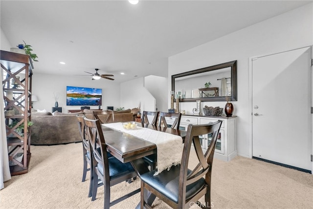 dining room with light carpet, a ceiling fan, and recessed lighting