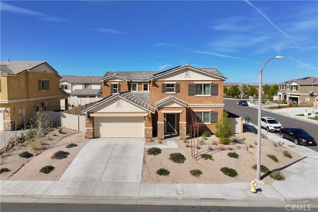 view of front of home with concrete driveway, a tile roof, a residential view, and fence