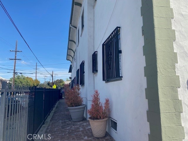 view of home's exterior with fence and stucco siding