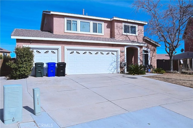 traditional-style house with driveway and stucco siding