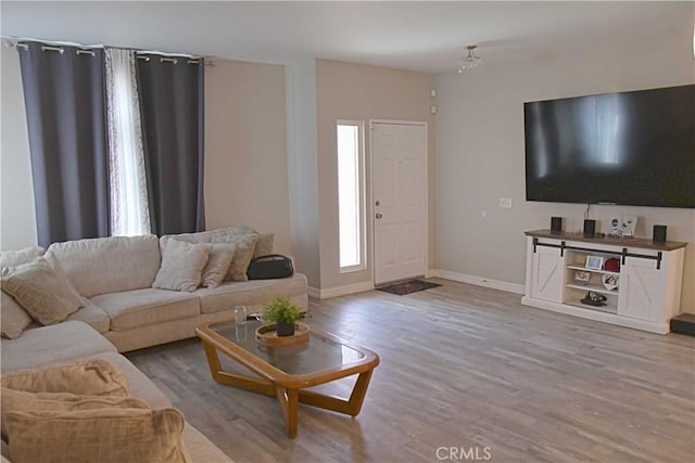 living room with baseboards and wood finished floors