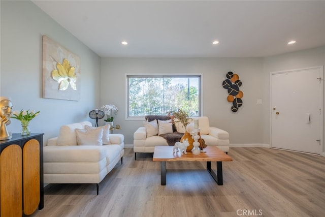 living room featuring light wood-style flooring, baseboards, and recessed lighting