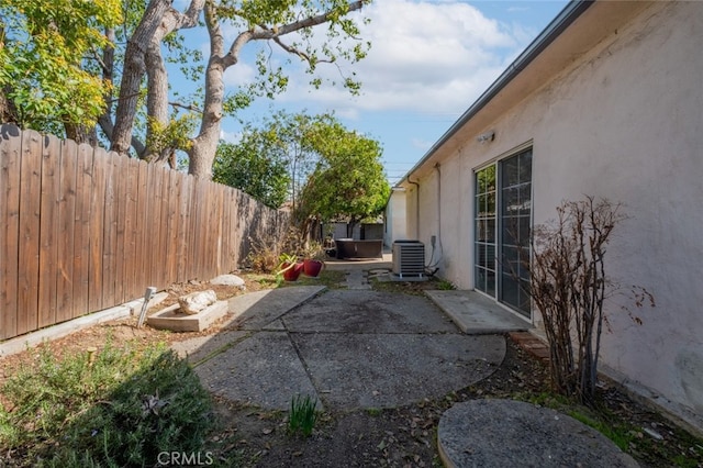 view of patio with a fenced backyard and cooling unit