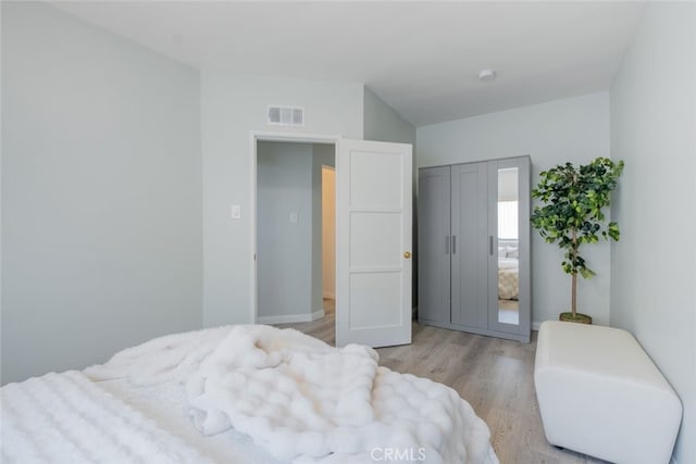 bedroom with visible vents and light wood-style flooring