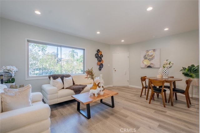 living room with light wood-type flooring, baseboards, and recessed lighting