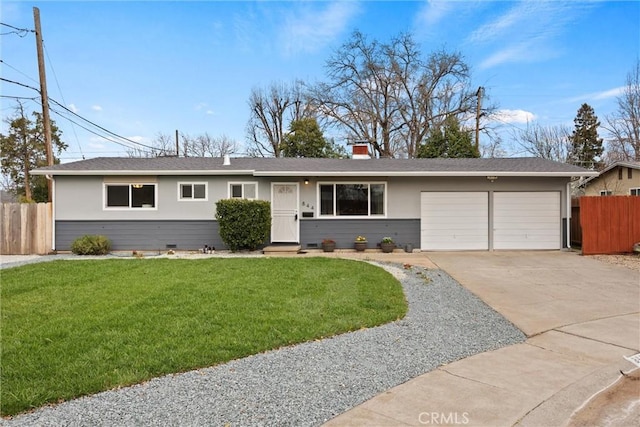 ranch-style house featuring a chimney, an attached garage, a front yard, fence, and driveway