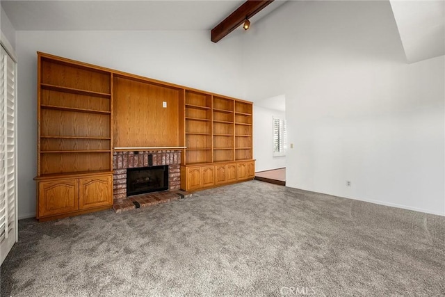 unfurnished living room with carpet floors, a brick fireplace, beamed ceiling, and high vaulted ceiling