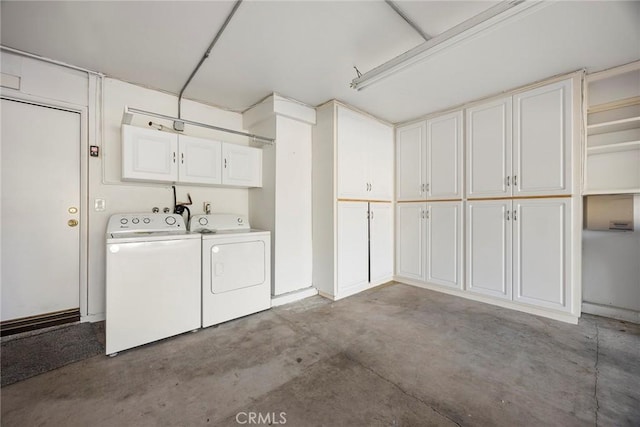 washroom featuring cabinet space and washer and dryer