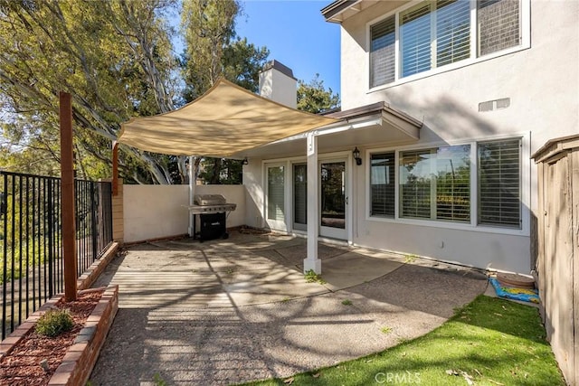 view of patio with a grill and a fenced backyard