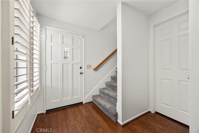 entrance foyer featuring stairway, wood finished floors, and baseboards